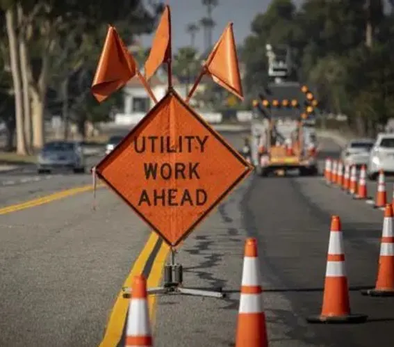 Utility work ahead signage with cones and lane control setup ensuring safe traffic flow and work zone compliance