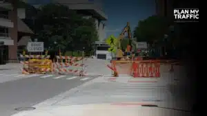 Road closure setup with barriers and signage following a construction traffic control plan template in BC.