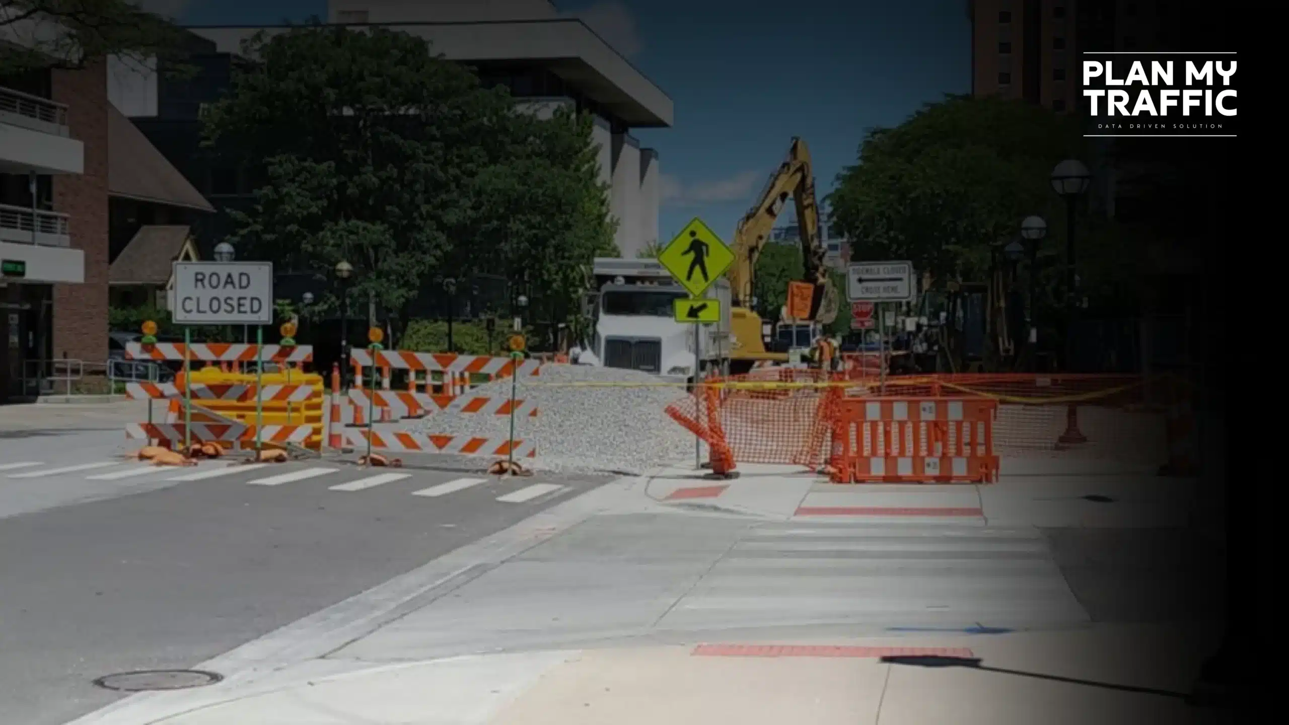Road closure setup with barriers and signage following a construction traffic control plan template in BC.