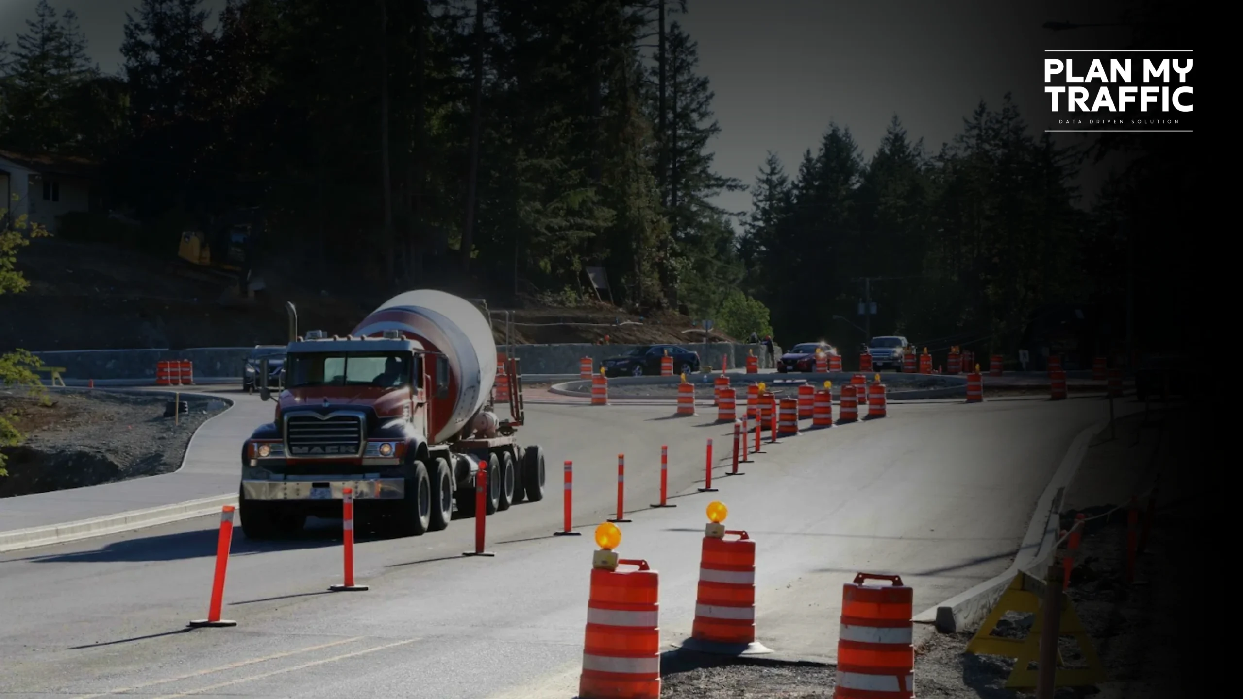 Concrete truck driving through cone setup showing Traffic Management Plan in road construction zone