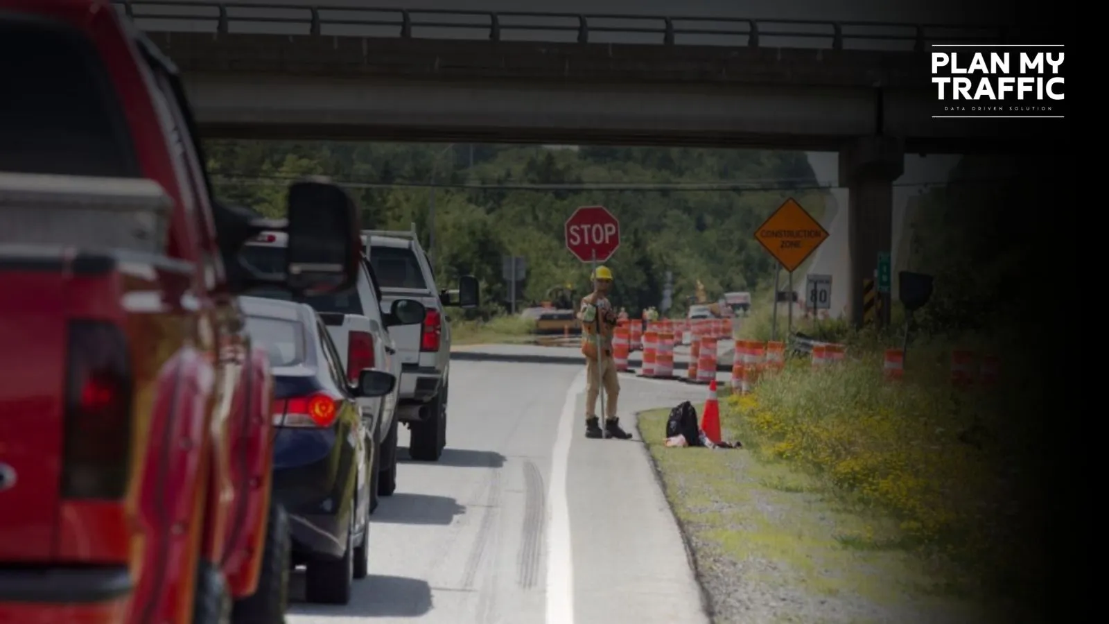 Traffic control worker managing lane closure for Traffic Management Plan Surrey road work
