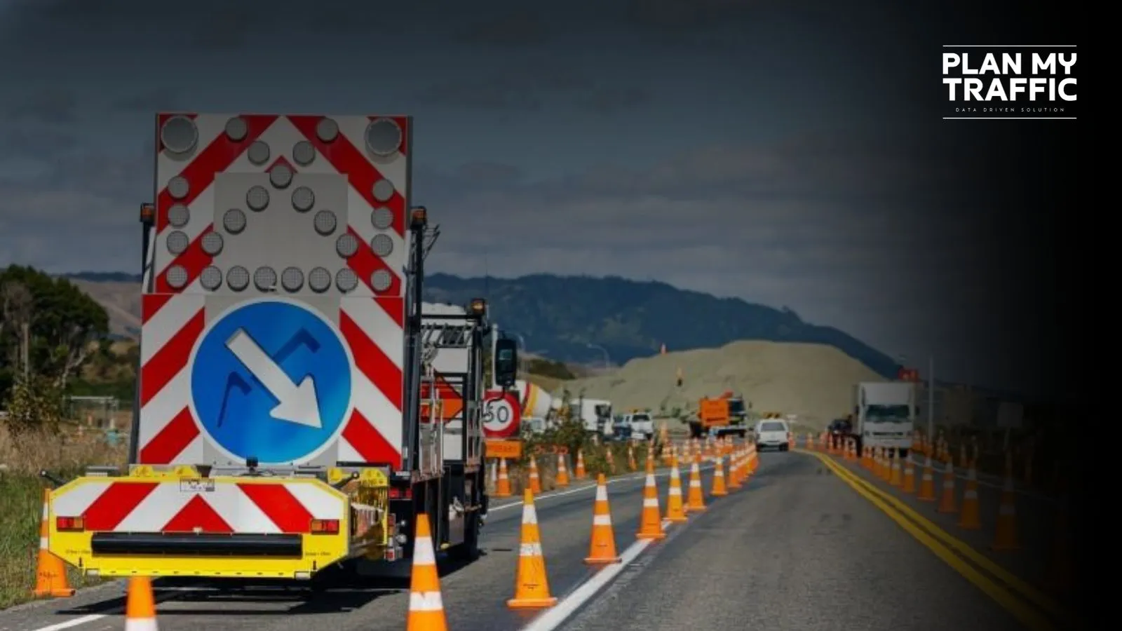 Traffic control truck and cones guiding vehicles through work zone areas on highway