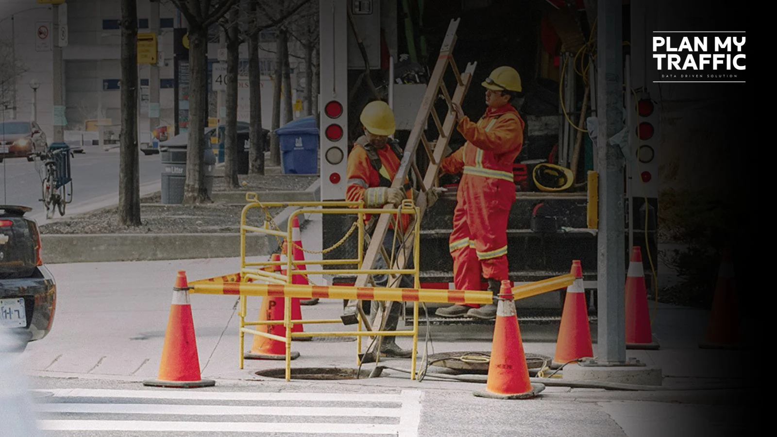 Workers setting up cones and barriers for Work Zone Traffic Control Plan in urban street