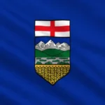 Flag of Alberta: royal blue background with the provincial shield of arms at center, depicting the Cross of St. George at top, Rocky Mountains with foothills in the middle, and a golden wheat field at the bottom.